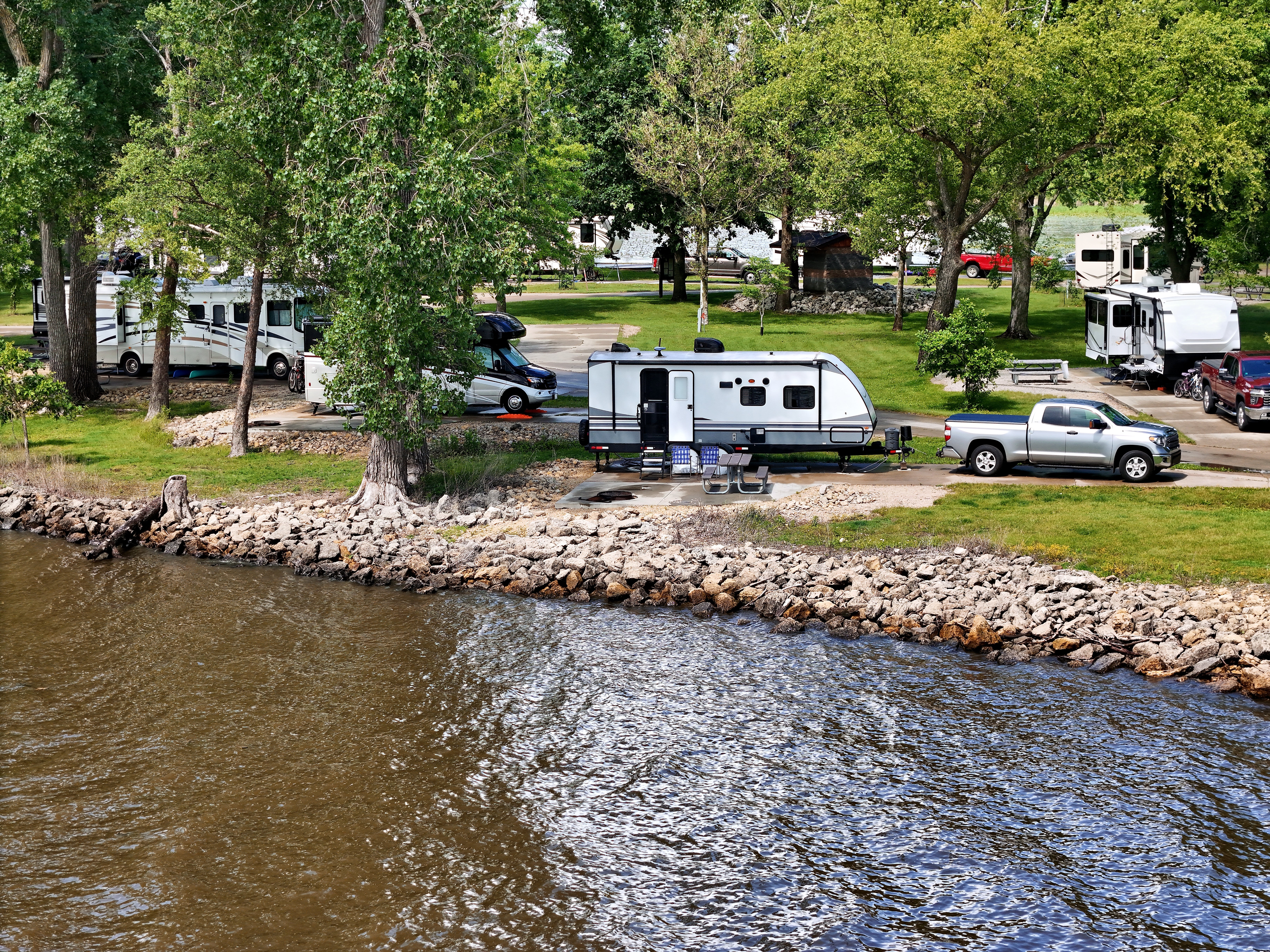 travel trailer in campsite on a river